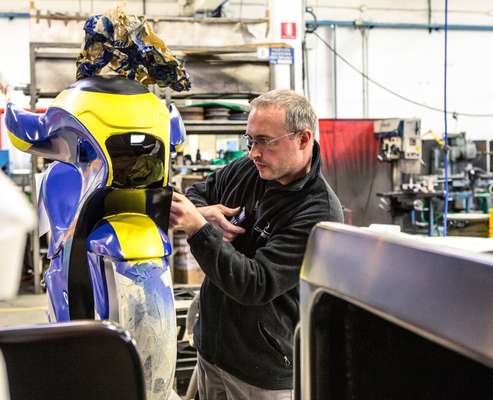 An employee inspects a MotoCoaster seat