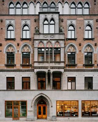 Street-facing façade of Block C with the original stone eagle and owl