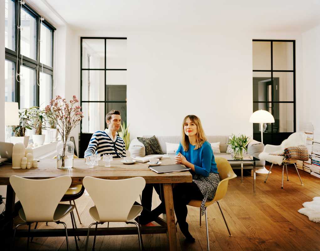 Carin Wester and Thomas Pouverel at their dining table with a mix of Jacobsen and Eames chairs