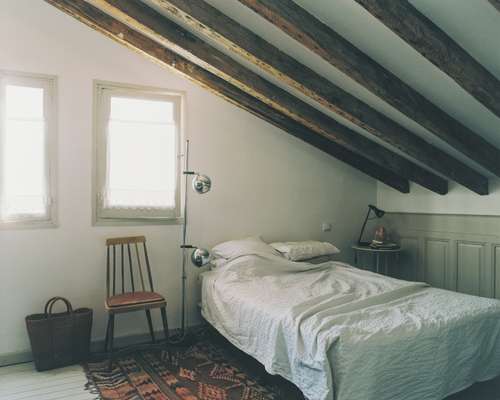 Airy wooden-beamed bedroom