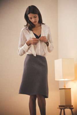 Blouse by Nicole Farhi, Bra by Eres, Skirt by Hermes, Tights by Falke, Watch by Cartier