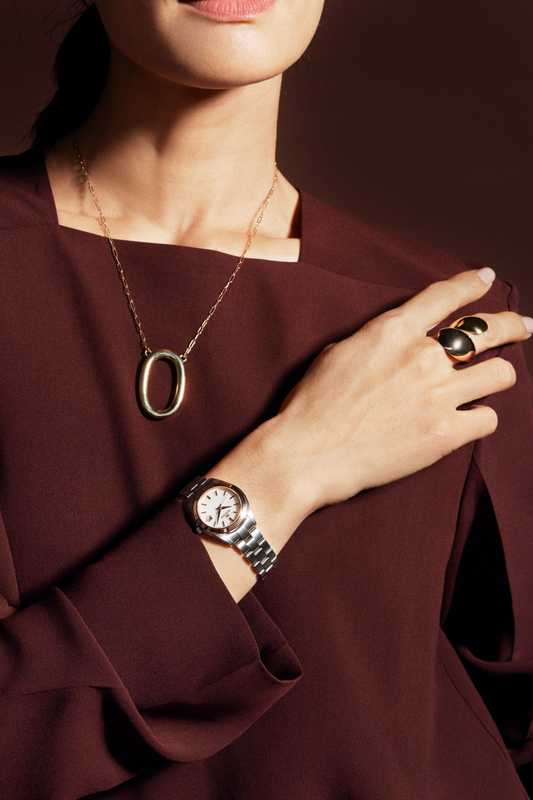 Pullover top by Cos, necklace by Laura Lombardi, ring by Charlotte Chesnais, watch by Grand Seiko