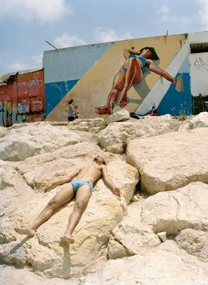 Mario, 25, Spanish dancer with Batsheva dance company, hard at work on his suntan