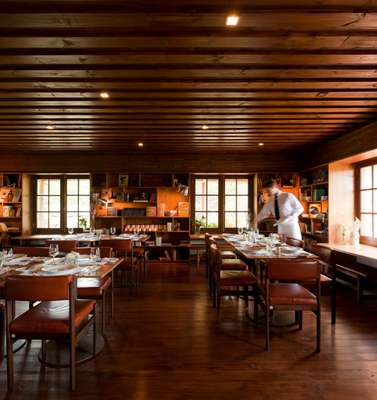 Waiter sets tables at Las Piedras restaurant