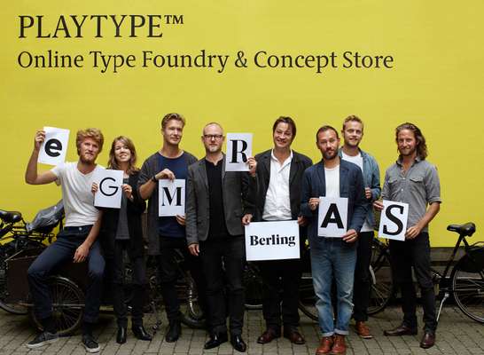 E-Types staff holding printouts of their font designs, including creative director Jens Kajus (holding “R”) and co-founder Jonas Hecksher (holding “Berling”)