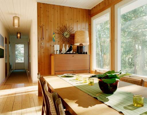 The dining table connects the living area to the hall and bedrooms beyond