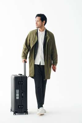 Coat by Pine, jacket and trousers by United Arrows, shirt by Head Porter Plus, trainers by Adidas Originals, suitcase by Rimowa, passport case by Porter