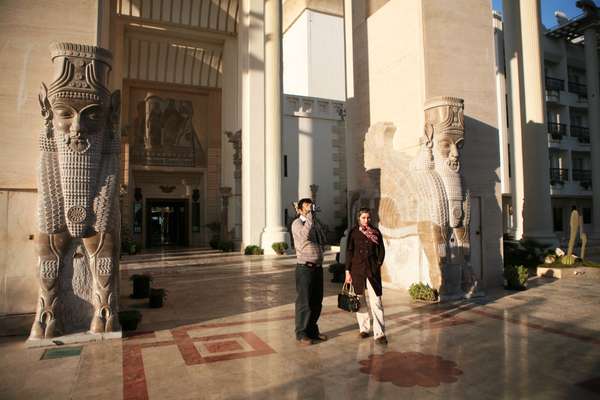 Tourists take photos of the view from the Dariush