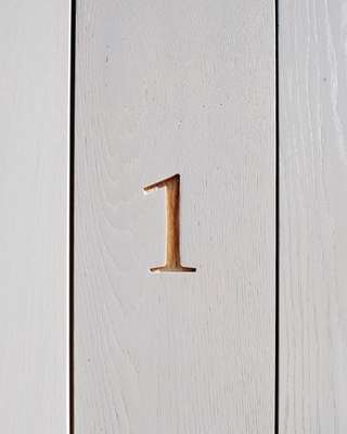 The house number was carved into the oak
