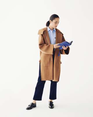 Coat and trousers by Sofie D’Hoore, shirt by Jacob Cohën, shoes by JM Weston, travel wallet by Valextra