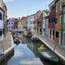 The canals of Murano are lined with  glassware shops