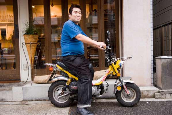 Dai Nagao, 39, a restaurant owner with his customised Yamaha Chappy on his way through Yoyogi-uehara. He uses this scooter while sourcing food for restaurants. He has been a scooter rider for seven years