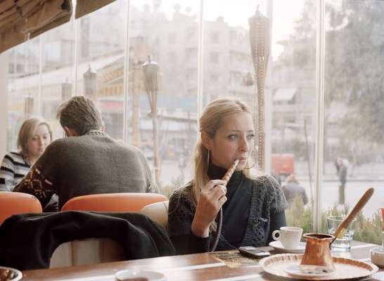 Smoking hookah in Monroe café in the Christian neighbourhood of Al-Aziziah