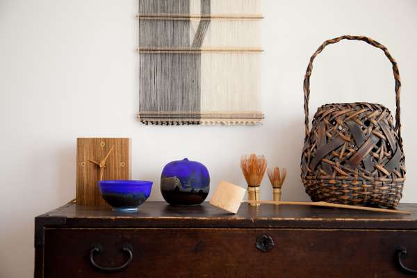 Art objects including wooden clock by Bob Stocksdale and ceramic vessels by Toshiko Takaezu