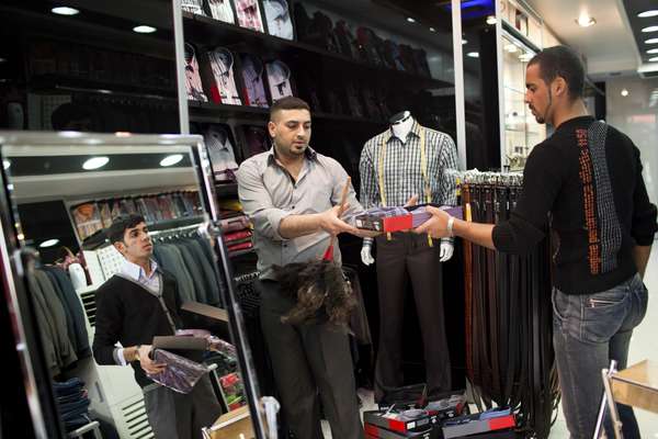 Walid Sultani, Saif Samir and Hassenin Asad at their men's clothing shop