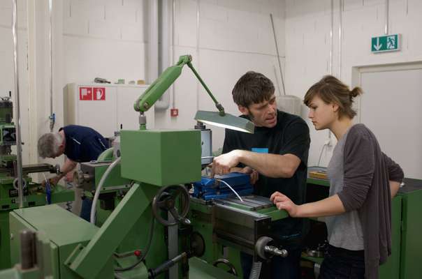 Workshop assistant helps a student 