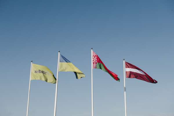 Flags of Latvia, Belarus and Ukraine (and the airline) flying over Riga Airport 