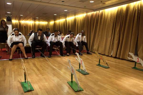 Officers play a dog-sled pulling game in the main lounge