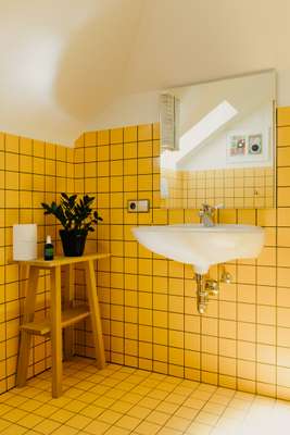 Egg yolk tiles in the upstairs bathroom 