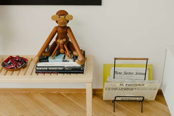 Mid-century modern monkey from Kay Bojesen,  Artek bench and Fornasetti newspaper stand 