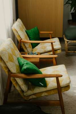 Cushions from Stockholm’s Svenskt Tenn; the mid-century chairs were found for the residents by their upholsterers
