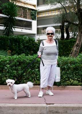 Resident taking her furry friend for a stroll