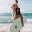 Surf instructor showing  a young pupil how to stay  on top of the waves 