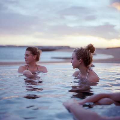 Swimmers in a geothermal pool at Ylstrondin Nautholsvik