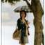 Jacket, skirt, bag by Louis Vuitton, blouse by Chloé, umbrella by Traditional Weatherwear, earrings by Duna