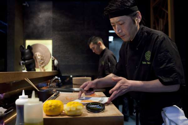 Head chef Takeo Yamazaki prepares salmon yuzu