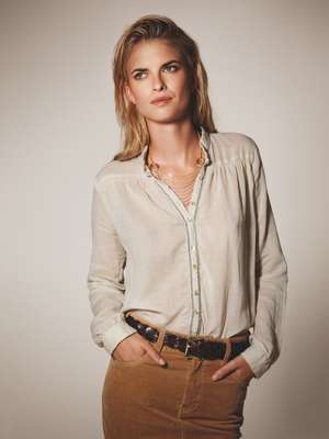 Shirt by Bagutta, necklace by Cartier, belt by J&M Davidson, skirt by Macphee