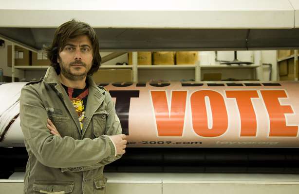 Sami Saab, creative director of Michel Aoun’s Free Patriotic Movement campaign, in front of an election poster he designed