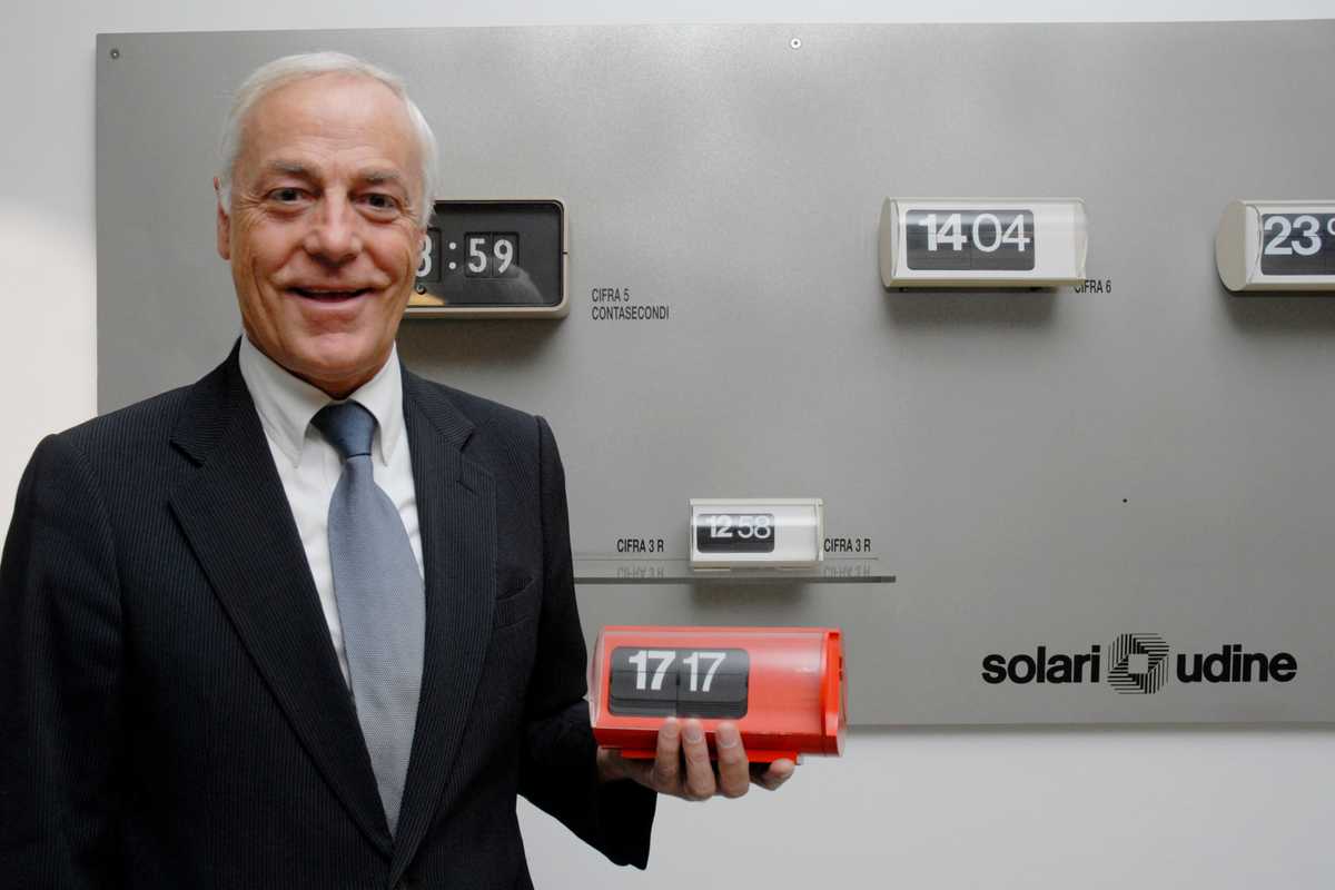 Solari president Massimo Paniccia holds a Cifra 3 clock 