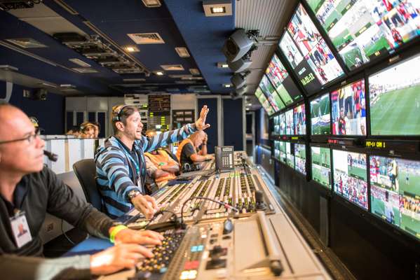 Inside a mobile broadcast unit during a live transmission of a football match at the Maracanã
