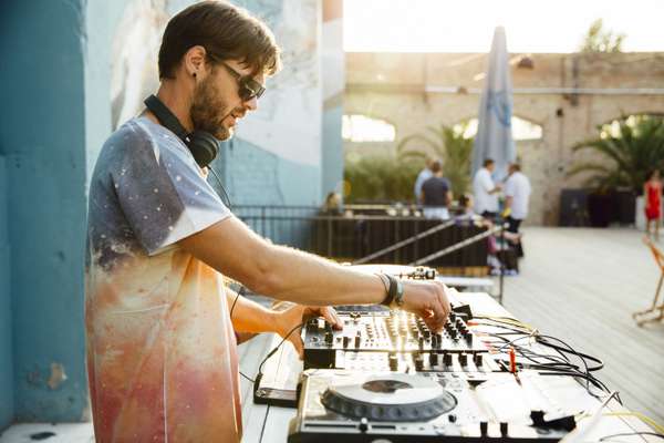As the sun goes down, a DJ turns it up