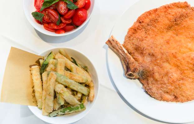 Veal Milanese with sides of tomatoes and ‘zucchini fritti’