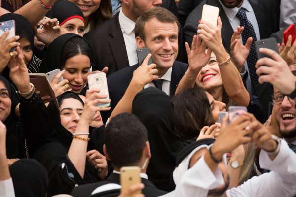 A mobbed Macron steps off the red carpet 