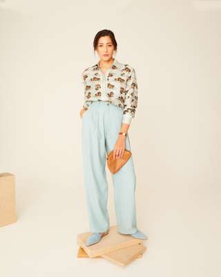 Shirt and clutch by Bottega Veneta, trousers by Bally, mules by Aeyde, watch by Cartier
