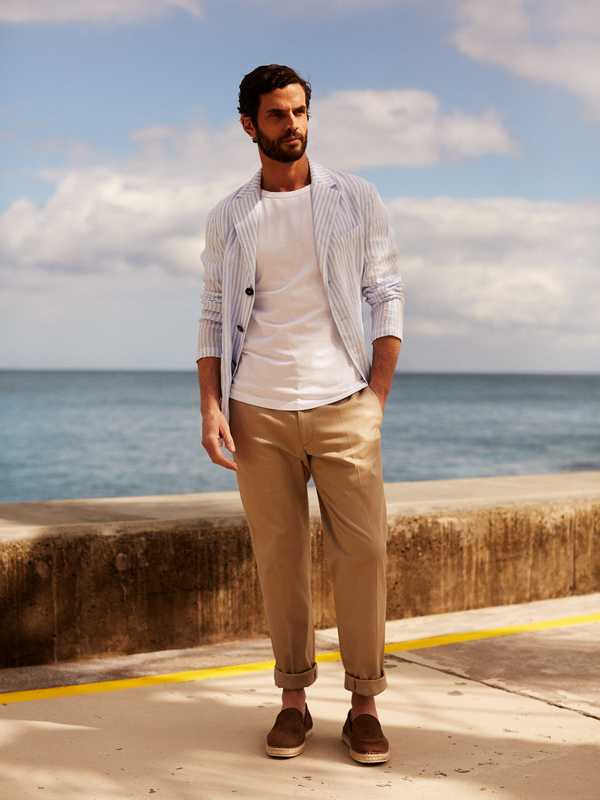 Jacket by Barena Venezia,  t-shirt by Ron Dorff, trousers by Brioni, slip-ons by Tod’s