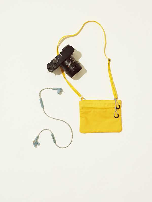 Bag by Arket, camera by Leica, earphones by Bang & Olufsen