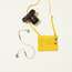 Bag by Arket, camera by Leica, earphones by Bang & Olufsen