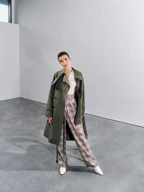 Coat by Sealup, bodysuit and trousers by Agnona, shoes by Bally, earrings by Tiffany & Co