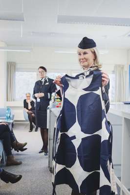 Instructor holding the new Marimekko-designed apron