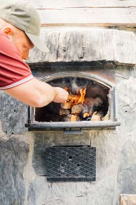 Stoking  the smoke sauna