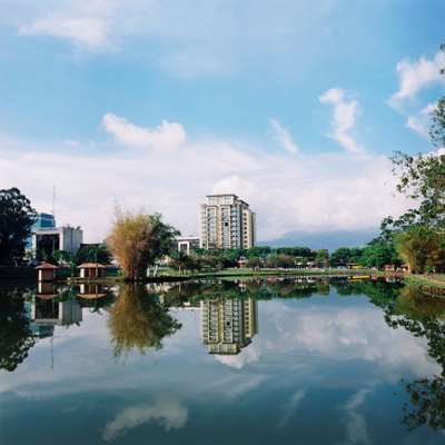 Modern buildings and quiet water in Parque La Sabana