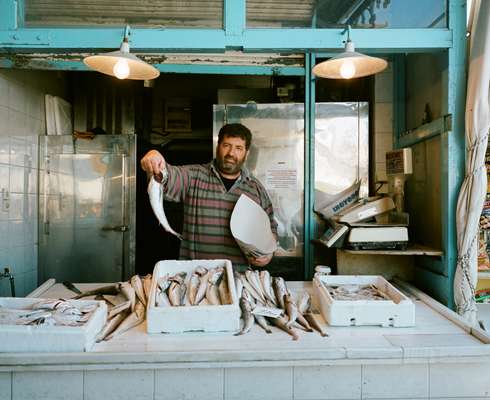 Vendor showing off his produce at Aegina’s main fish market