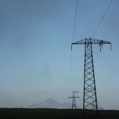 The Koryaksky volcano smokes beyond pylons outside Petropavlovsk