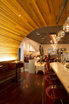 The restaurant’s high, wood-covered ceiling