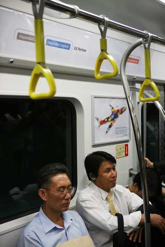 South Korean commuters inside a Line 9 subway car 