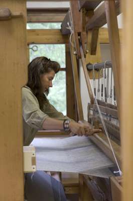 Emy Maguet works on a loom